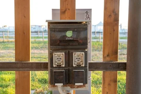 Power outlet box for e-bikes mounted on wooden wall Photos