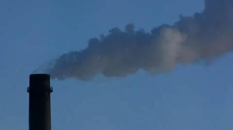 Power plant with smokestacks belches smoke steam into the air sky. Stock Footage