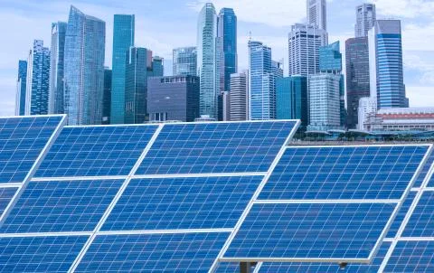 Power plant using renewable solar energy with city building background Stock Photos