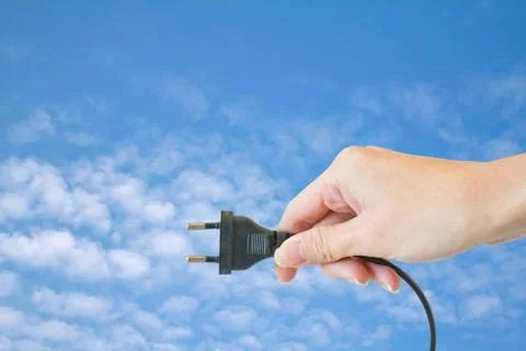 Power plug in a hand on a white background Foto stock