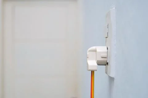 The power plug is plugged in the switch. Stock Photos