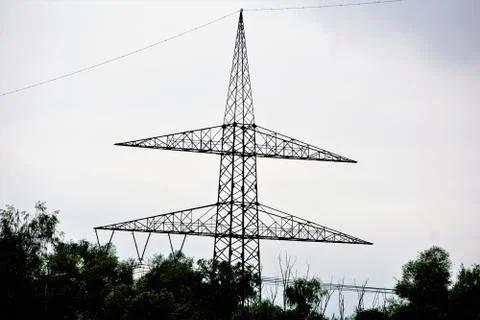 An power pole behind trees Stock Photos