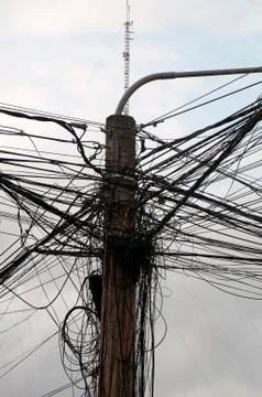 Power pole with electrical wiring typical of Southeast Asia Stock Photos