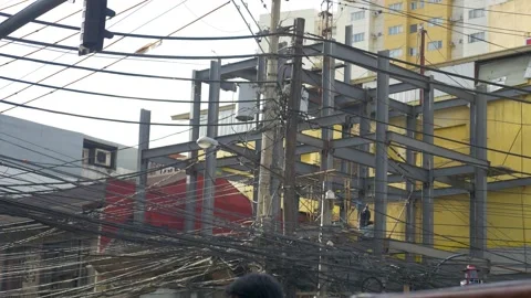 A power pole saturated with wire in downtown Manila, Philippines Stock Footage 235466363