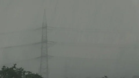 Power pylon almost disappearing from sight in heavy rain, weather, electricity Stock Footage 90440735