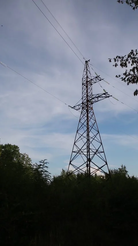 Power pylon silhouette against a cloudy sky Stock Footage 316599036