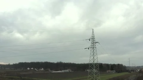 Power pylons and high voltage lines in an agricultural landscape. High-voltage. Stock Footage 146010883