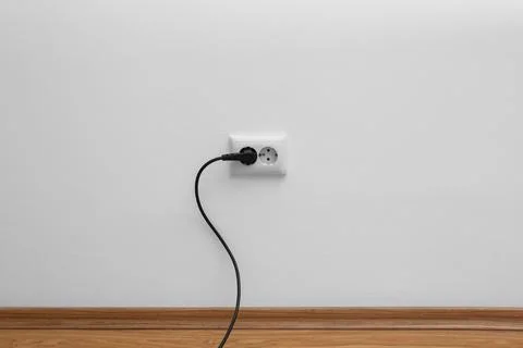 Power socket and plug on wall indoors. Electrician's equipment Stock Photos