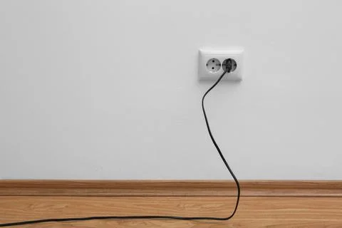 Power socket and plug on wall indoors, space for text. Electrician's equipmen Stock Photos
