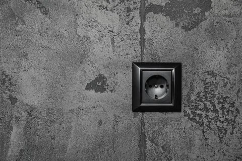 Power socket on grey wall, space for text. Electrical supply Foto stock