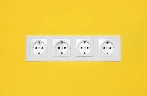 Power sockets on yellow wall. Electrical supply Foto stock