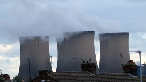Power station brick cooling chimney stacks smoking above residential Video stock 118220165