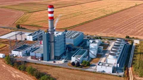 Power station buildings with a striped stack and cooling fan bank. Gray Stock Footage 346483766