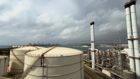 Power station chimneys pipework storage tanks marsaxlokk bay malta stormy Видео 343677623