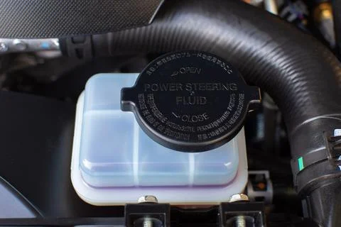 Power steering fluid reservoir in engine bay Stock Photos