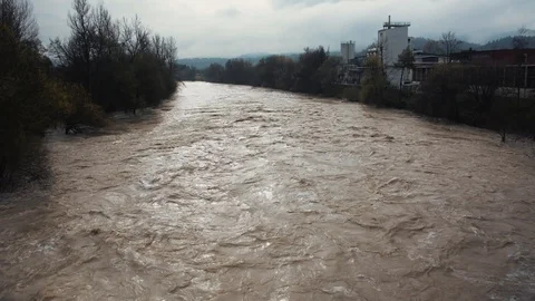 Power stream dirt mud water overflowing after season rainfall Stock Footage 120033264
