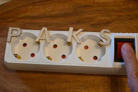 Power strip labeled Paks with switch being pressed Stock Photos