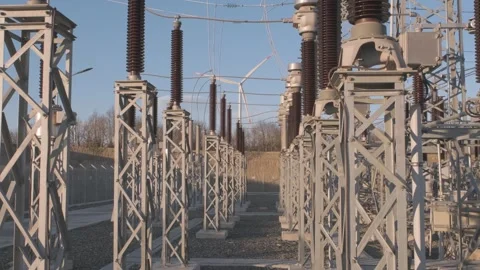 Power Substation with Wind Turbine in the Background Stock Footage 282925224