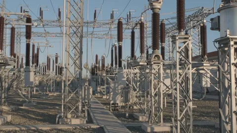 Power Substation with Wind Turbine in the Background Stock Footage 282925254