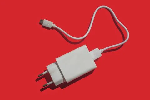 Power supply with removable usb cable on a red background Stock Photos