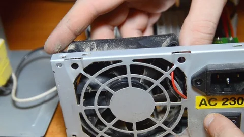 Power supply repair. Computer technician disassembles a computer. master removes Stock Footage 102954711