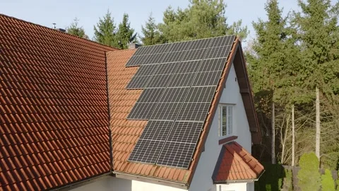 The power supply system from solar cells on the tiled roof of a private house. Stock Footage 255321179