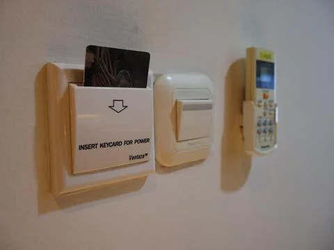Power switch and key card on wall Stock-Fotos