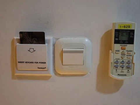 Power switch and key card on wall Stock-Fotos