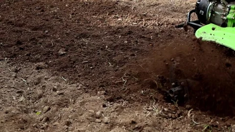 Power Tiller Wheel Plowing Deep Soil In Agricultural Field Slow Motion Video Stock Footage 336497714