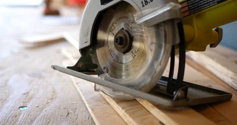 A power tool circular saw on a stack of plywood boards on a construction 스톡 동영상 102167494
