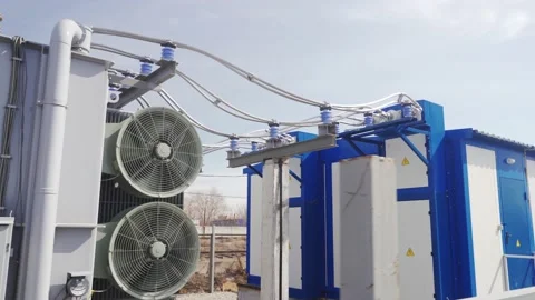 Power transformer with cables at electrical distributing substation on sunny day Vídeo Stock 159146748