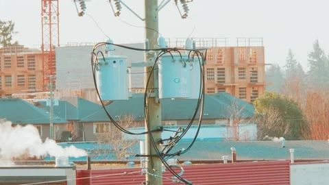 Power transformer on utility pole in suburban neighborhood Stock Footage 333605734