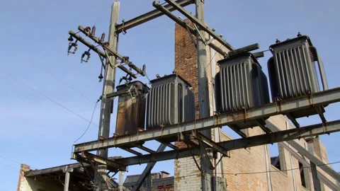 Power transformers outside an old brick building. 4k60p Stock Footage 131111554
