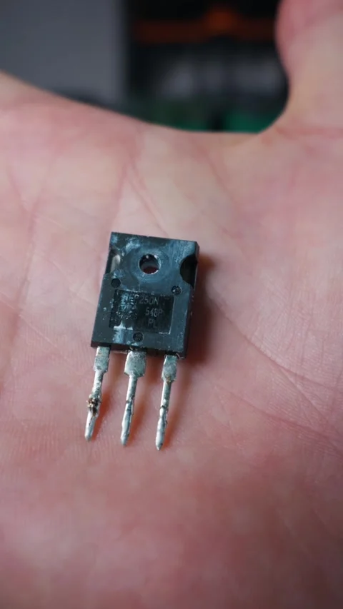 Power Transistor Irfp250n Held in Hand for Electronic Component Demonstration Stock Footage 339364771