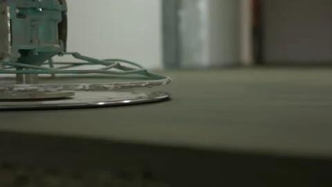 Power trowel rotating over fresh concrete floor for smooth finish Stock-Footage 344473532