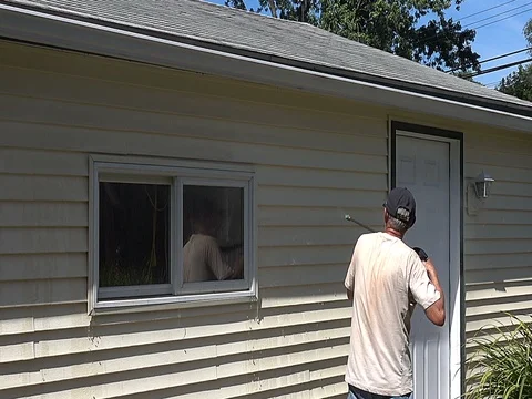 Power washing garage from winters dirt and grime Stock Footage