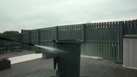 Power Water jet cleans trash bin on wooden deck 2 of 3 videos Stock Footage 340827722