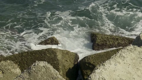 Power waves hitting rocks. 4K Stock Footage 240849918