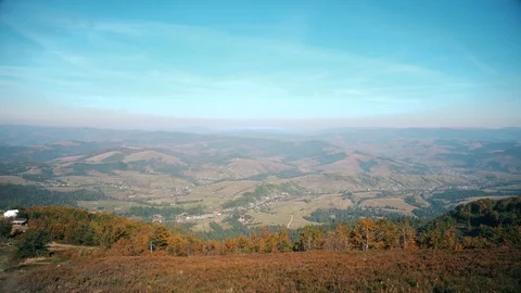 Power windmills in the mountains at sunset. Camera panning under a sunset light  Stock Footage 98377461