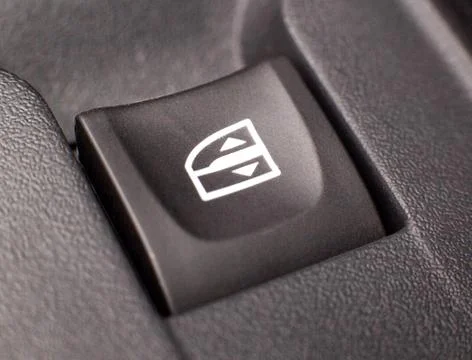 Power window button in a modern car, background, closeup Photos