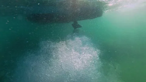 Powerboat propeller creates powerful current and lots of air bubbles fly on lens Stock Footage 297540983