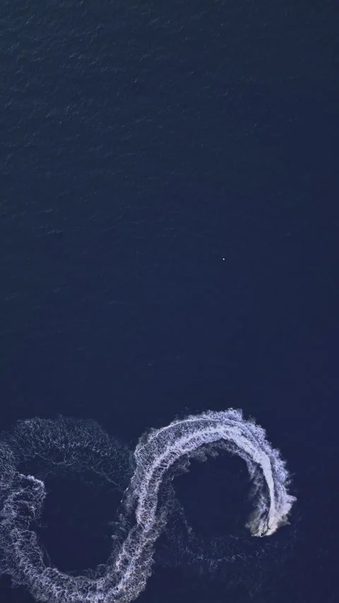 Powerboat turns loop number eight on the sea making infinity future concept Stock Footage 283565227