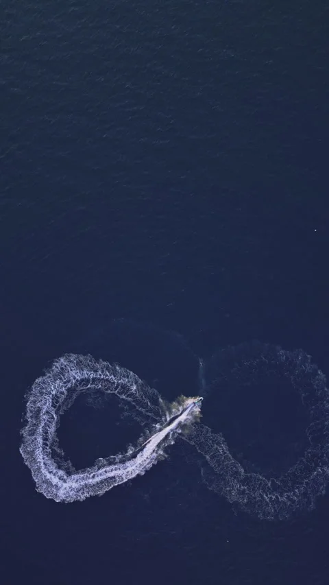 Powerboat turns loop number eight on the sea making infinity future concept Stock Footage 283566750