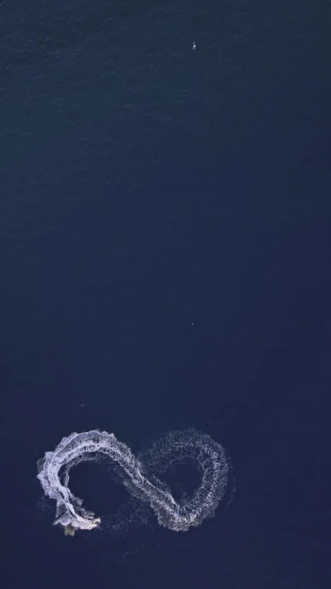 Powerboat turns loop number eight on the sea making infinity future concept Stock Footage 283568482