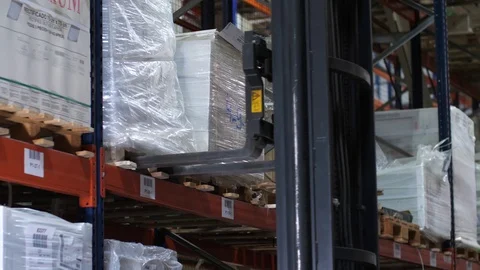 Powered forklift at a logistic warehouse. Behind the wheel of an employee. 4K Stock Footage 111766768