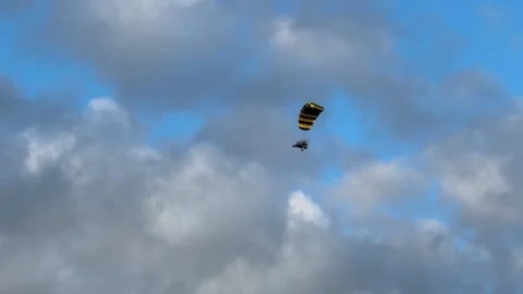 Powered parachute flies under clouds in late afternoon. Stock Footage 311217294