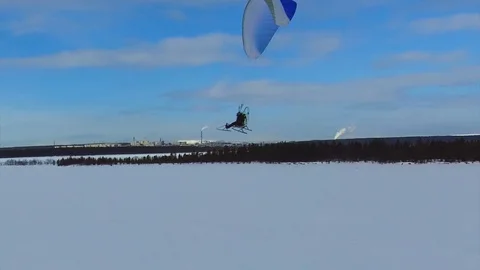 A powered paraglider flies in a circle Stock Footage 88388113