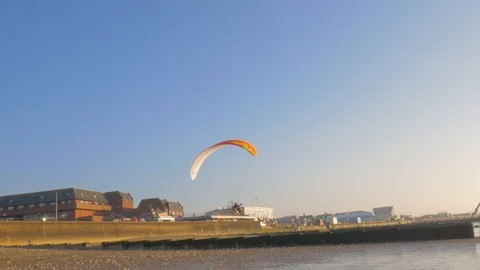 Powered paraglider flies over the seashore. Stock Footage 104792204
