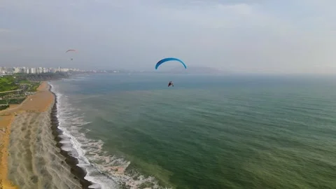 Powered paragliding flight over the pacific coast Video stock 296990789