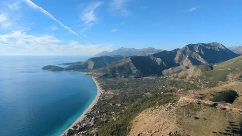 Powered paragliding paramotor flying over Albanian coast mountains and beaches Stock Footage 317488703